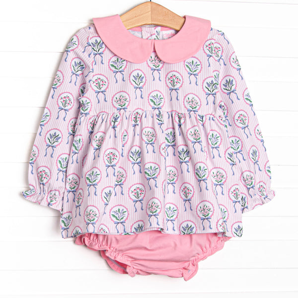  This set features a pink floral print, a peter pan collar, and pink diaper cover. 