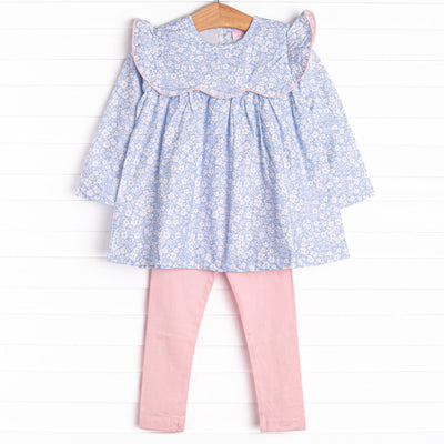  This set features a blue floral print, a ruffle bib with pink trim, and pink leggings to match. 