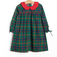 This dress features a tartan plaid print, a peter pan collar, and ties on the end of the sleeves.