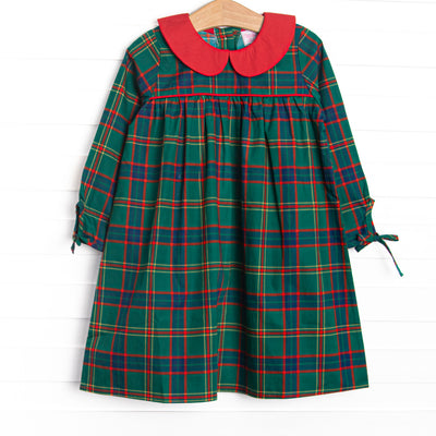 This dress features a tartan plaid print, a peter pan collar, and ties on the end of the sleeves.