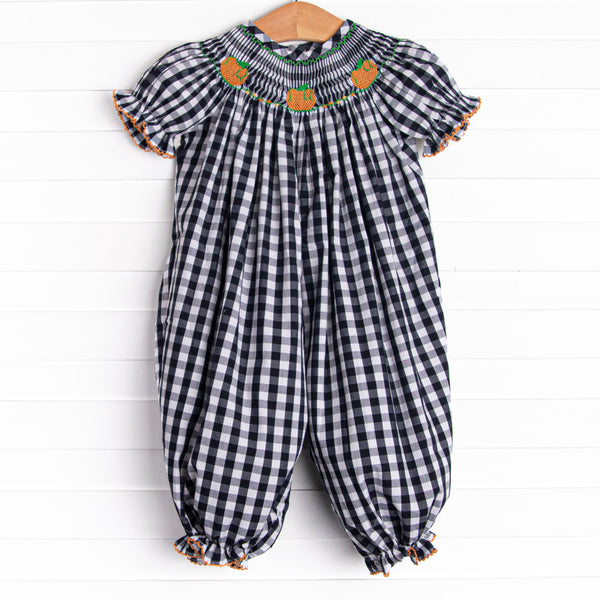 This romper features a navy check print, puff sleeves, and pumpkin smockings