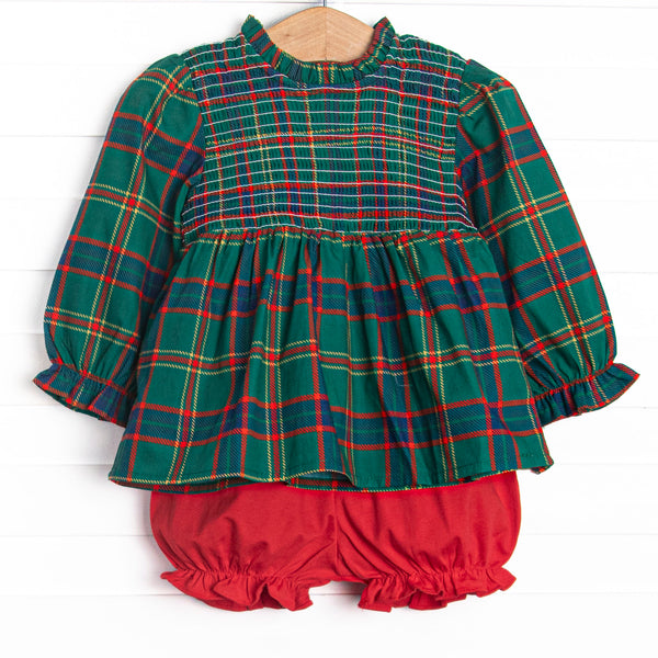 This set features a tartan plaid top with a smocking across the chest, and red bloomers to match.