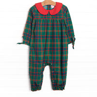  This romper features a tartan plaid print, a peter pan collar, and snaps on the stride. 