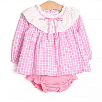 This set features a pink windowpane print top with a ruffle collar, and pink diaper cover to match.