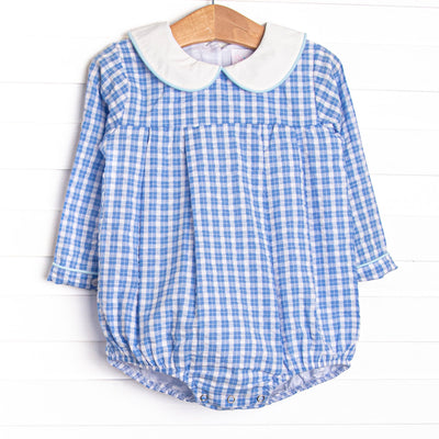  This bubble features a blue windowpane print, a peter pan collar, and snaps. 