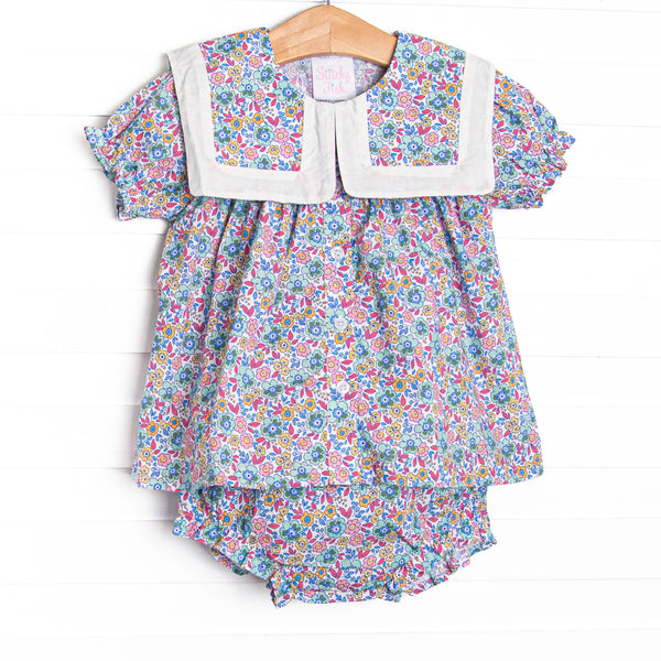  This set features a purple floral print, a bib collar, and puff sleeves. Matching diaper cover to complete the set. 