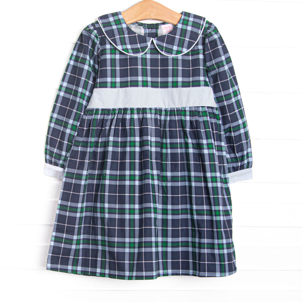  This dress features navy plaid fabric, a Peter Pan collar, and a light blue waist sash. 