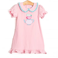 This dress features puff sleeves, a peter pan collar with mint striped ruffles, and a tea applique.