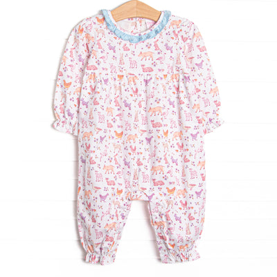  This romper features a farm animal print, a blue ruffle collar, and long sleeves. 