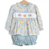  This set features a blue floral print, ruffle collar, and a turkey and pumpkin smocking. Coordinating blue bloomer shorts to match. 
