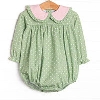  This bubble features a green polka dot print, pink ruffle trim, and snaps on the stride to make changing a breeze. 
