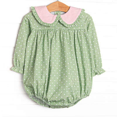  This bubble features a green polka dot print, pink ruffle trim, and snaps on the stride to make changing a breeze. 