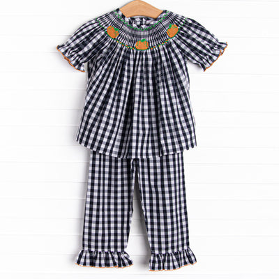  This set features a navy check print, puff sleeves, and pumpkin smockings. 