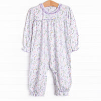 This romper features a purple floral print, a purple ruffle collar and the softest knit material.