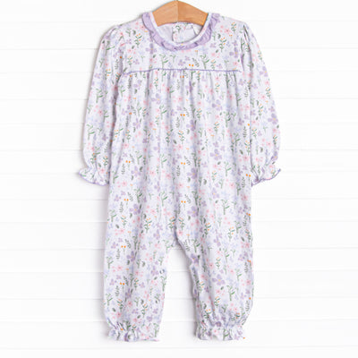This romper features a purple floral print, a purple ruffle collar and the softest knit material.