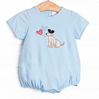 This bubble features a blue knit material, short&nbsp; sleeves, and puppy with balloons appliques.