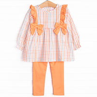 This set features an orange plaid print, orange bows, and coordinating orange leggings to match.