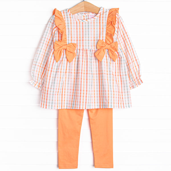 This set features an orange plaid print, orange bows, and coordinating orange leggings to match.