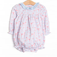 This bubble features blue striped fabric, a pink poodle print, and a blue ruffle collar.