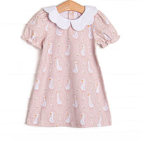 This dress features a pink geese print, a white scallop collar, and short puff sleeves.