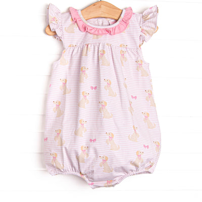 This bubble features a dog printed pink knit fabric, a hot pink ruffle collar, and flutter sleeves.