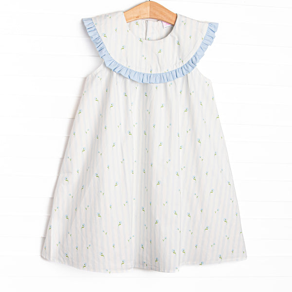This dress features blue floral and striped print, a blue ruffles, and a bib collar.