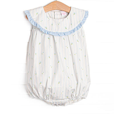 This bubble features blue floral and striped print, a blue ruffle edged bib collar, and snaps on the stride.