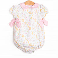  This bubble features a party animal print fabric, a pink Peter Pan collar, and short puff sleeves. 