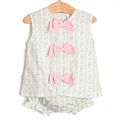 This set features a green floral print, pink bow details, and a matching diaper cover.