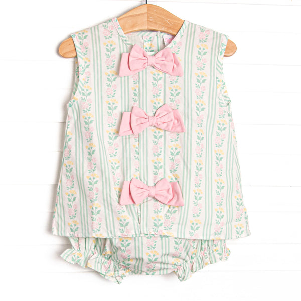 This set features a green floral print, pink bow details, and a matching diaper cover.