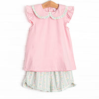 This set features a pink flutter sleeve top with a peter pan collar and ruffle trim. Coordinating green floral shorts with a bow detail to match.