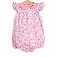This bubble features a floral and bow pink printed fabric, a hot pink gingham Peter Pan collar, and flutter sleeves.