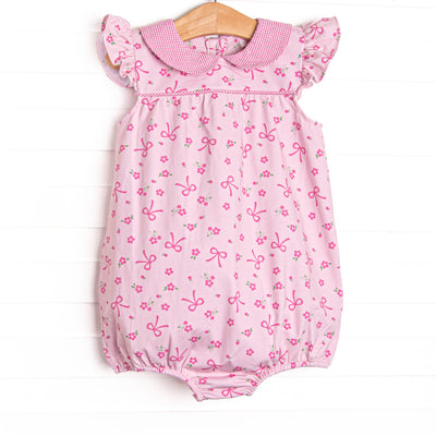 This bubble features a floral and bow pink printed fabric, a hot pink gingham Peter Pan collar, and flutter sleeves.