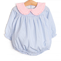  This bubble features light blue gingham fabric, a pink ruffle trimmed Peter Pan collar, and long sleeves. 