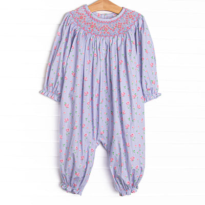  This romper features a blue floral print, snaps on the stride, and a dainty floral smocking. 