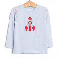 This long sleeve top features blue striped knit fabric, rocket ship applique, and blue neck trim.