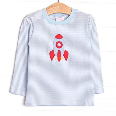 This long sleeve top features blue striped knit fabric, rocket ship applique, and blue neck trim.