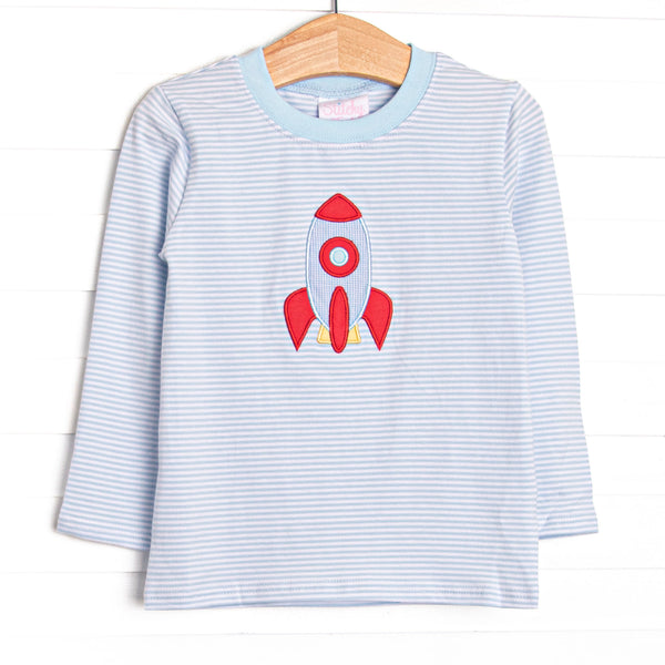 This long sleeve top features blue striped knit fabric, rocket ship applique, and blue neck trim.
