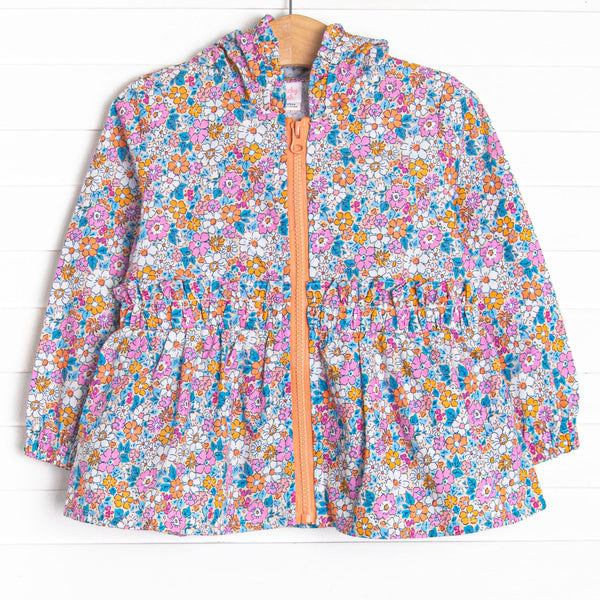 This hooded jacket features an orange floral print, an orange zipper, and ruffle trim.