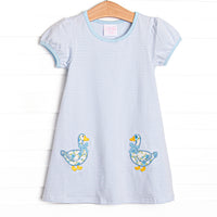 This dress features a blue striped knit fabric, double goose applique, and short puff sleeves.