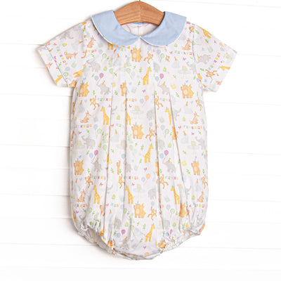  This bubble features a party animal print fabric, a blue Peter Pan collar, and short sleeves. 