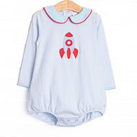 This long sleeve bubble features blue striped knit fabric, rocket ship applique, and a blue Peter Pan collar with red piping.