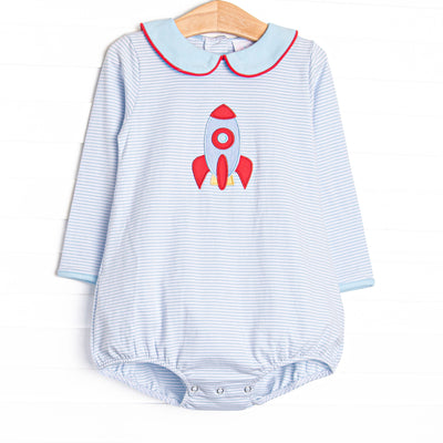 This long sleeve bubble features blue striped knit fabric, rocket ship applique, and a blue Peter Pan collar with red piping.