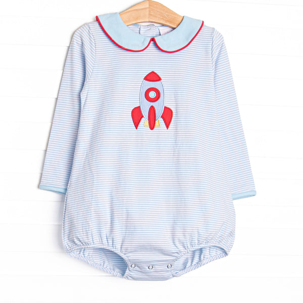 This long sleeve bubble features blue striped knit fabric, rocket ship applique, and a blue Peter Pan collar with red piping.