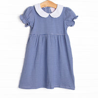  The Erin Dress is featured in royal blue striped print, puff sleeves. and a peter pan collar. 