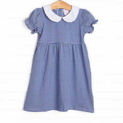  The Erin Dress is featured in royal blue striped print, puff sleeves. and a peter pan collar. 