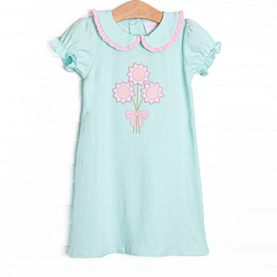  This dress features mint fabric, floral applique, and a mint, pink ruffle trimmed Peter Pan collar. 