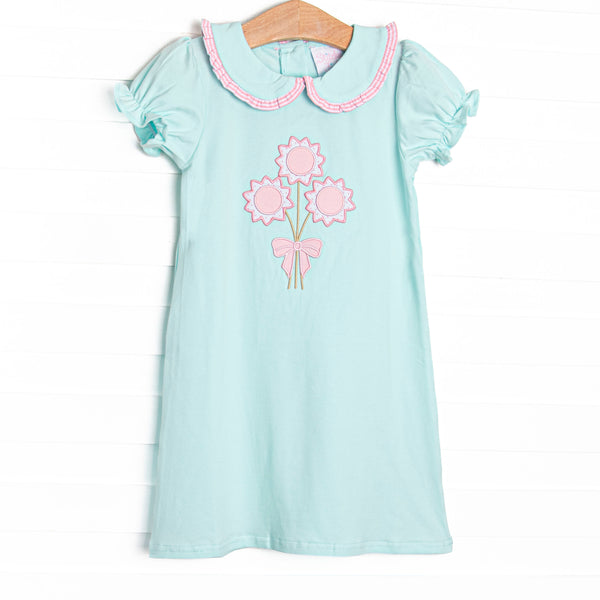  This dress features mint fabric, floral applique, and a mint, pink ruffle trimmed Peter Pan collar. 