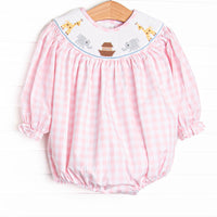  This long sleeve bubble is featured in a pink check print with Noah's Ark smocking. 