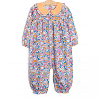  This romper features an orange floral print, an orange Peter Pan collar, and snaps along the stride to make changing a breeze. 